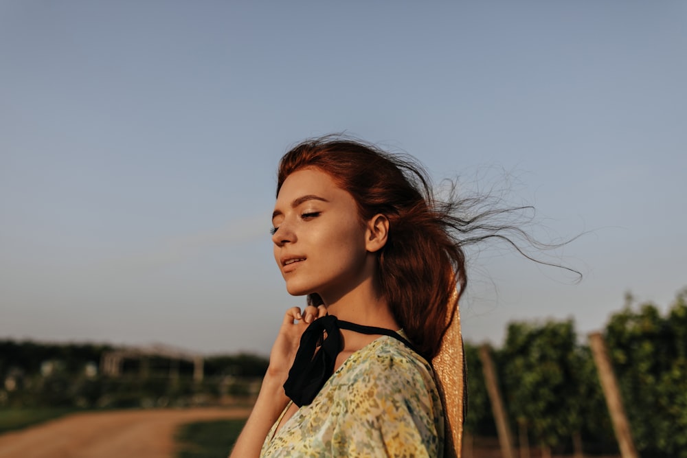 a woman with her hair blowing in the wind