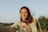 a woman is smiling while holding onto her tie