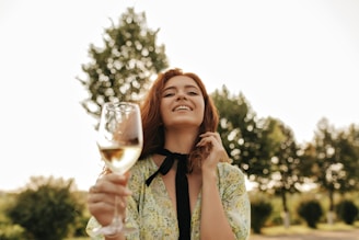 KWYRO, a woman holding a glass of white wine