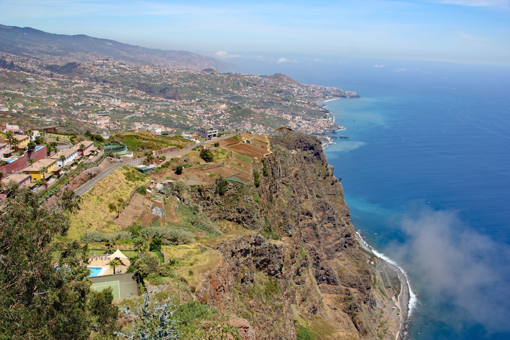 a scenic view of a town and the ocean