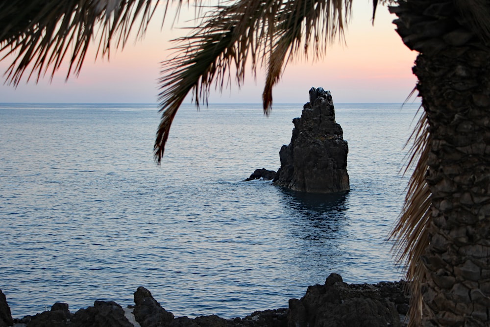 a rock formation in the middle of a body of water