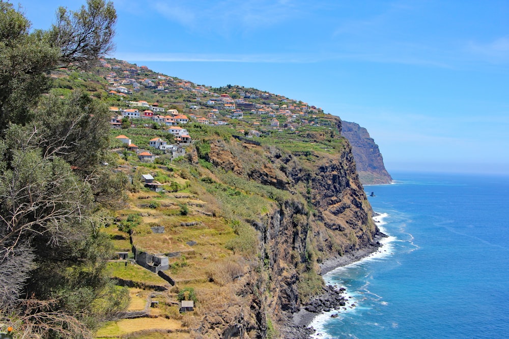 a scenic view of a small village on the side of a cliff