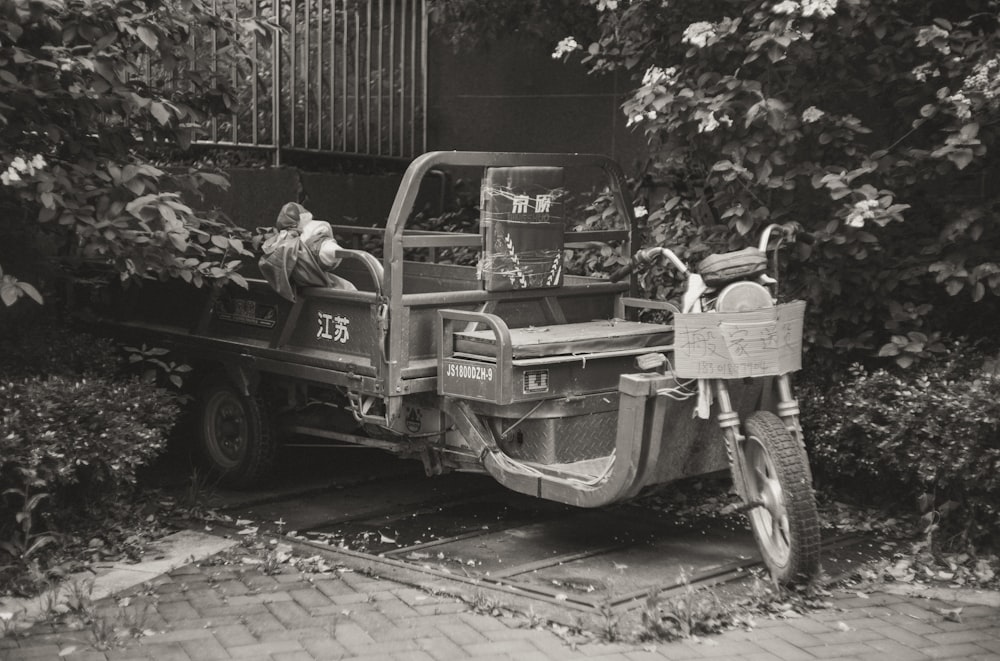 a black and white photo of a truck parked in front of a building