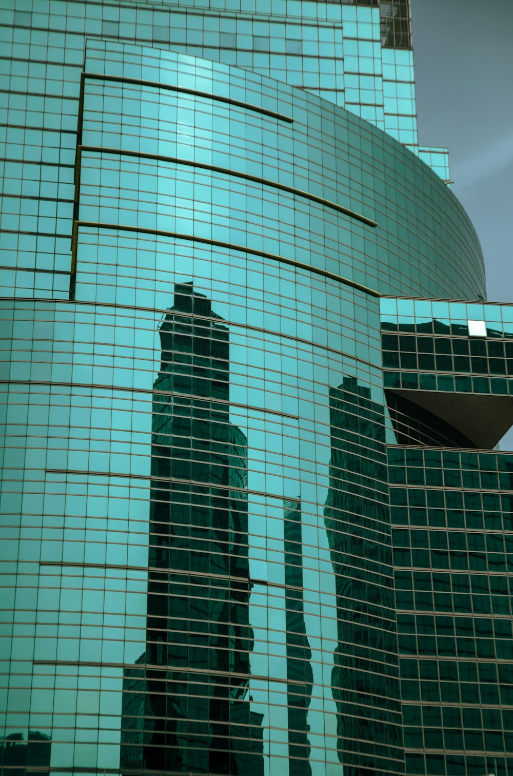 a reflection of a building in the glass of another building