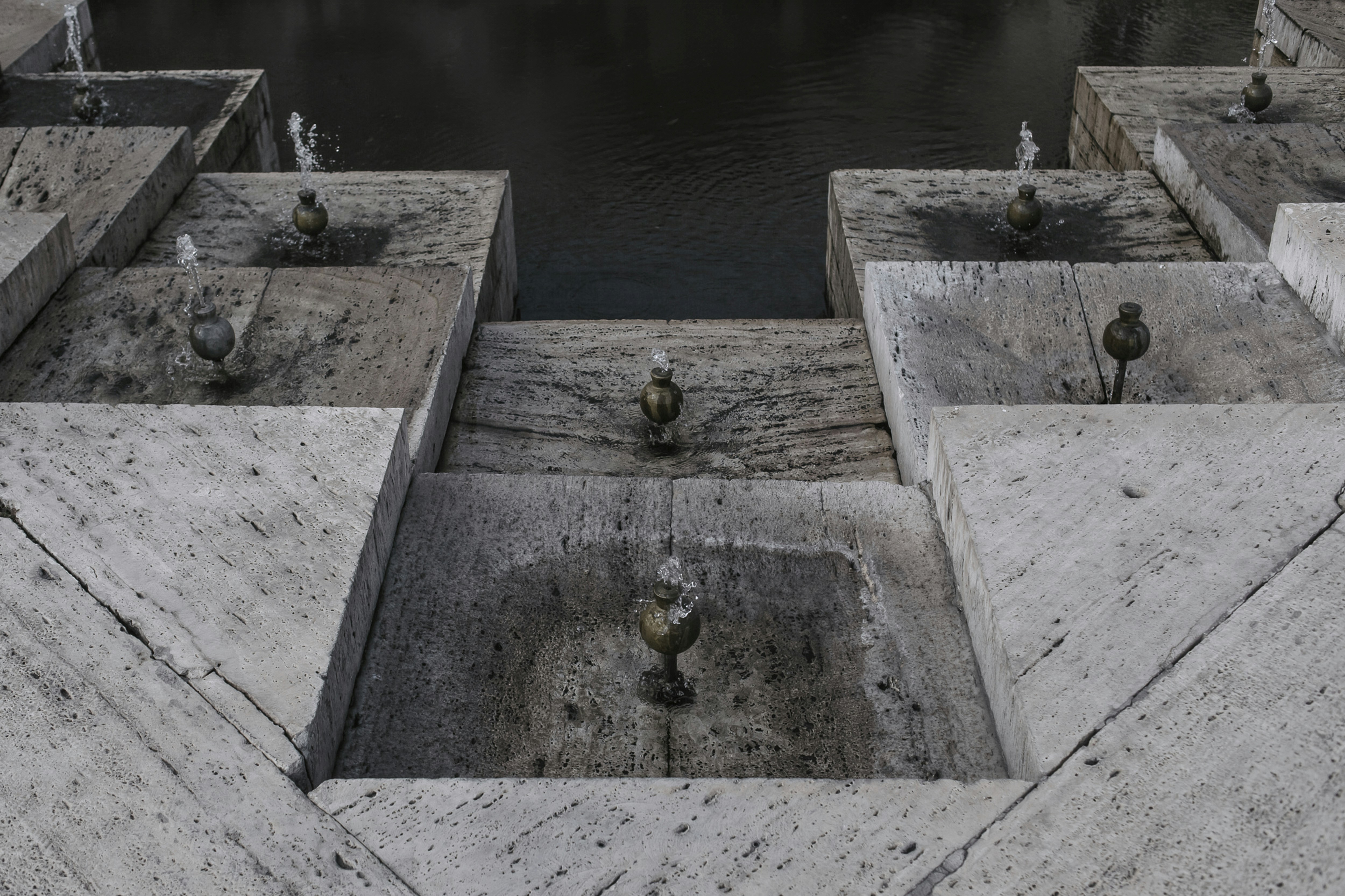 a group of concrete blocks sitting next to a body of water
