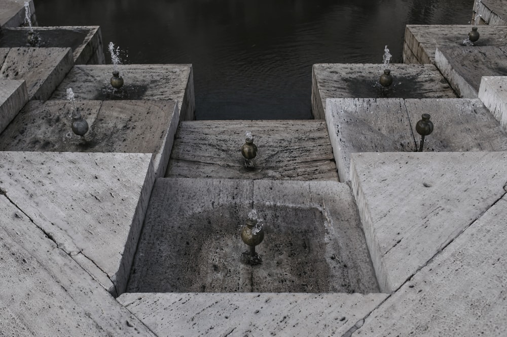 a group of concrete blocks sitting next to a body of water