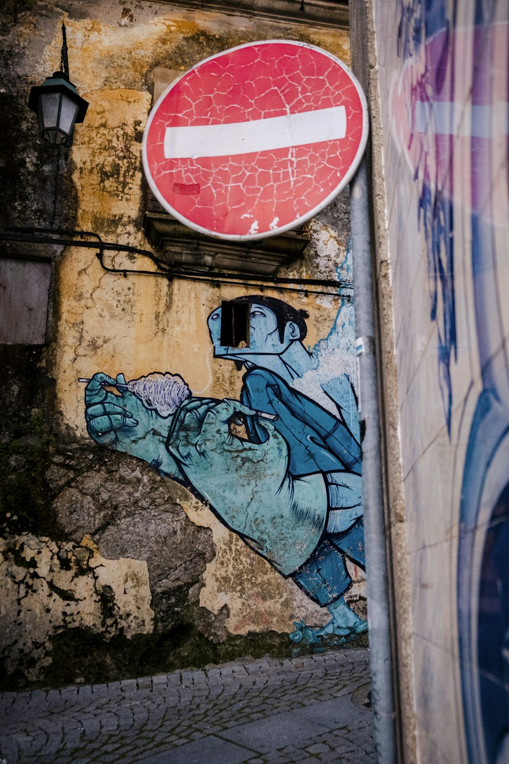 a painting of a man riding an elephant next to a stop sign