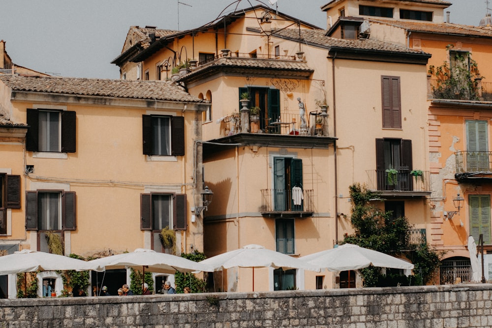 a row of buildings with umbrellas in front of them