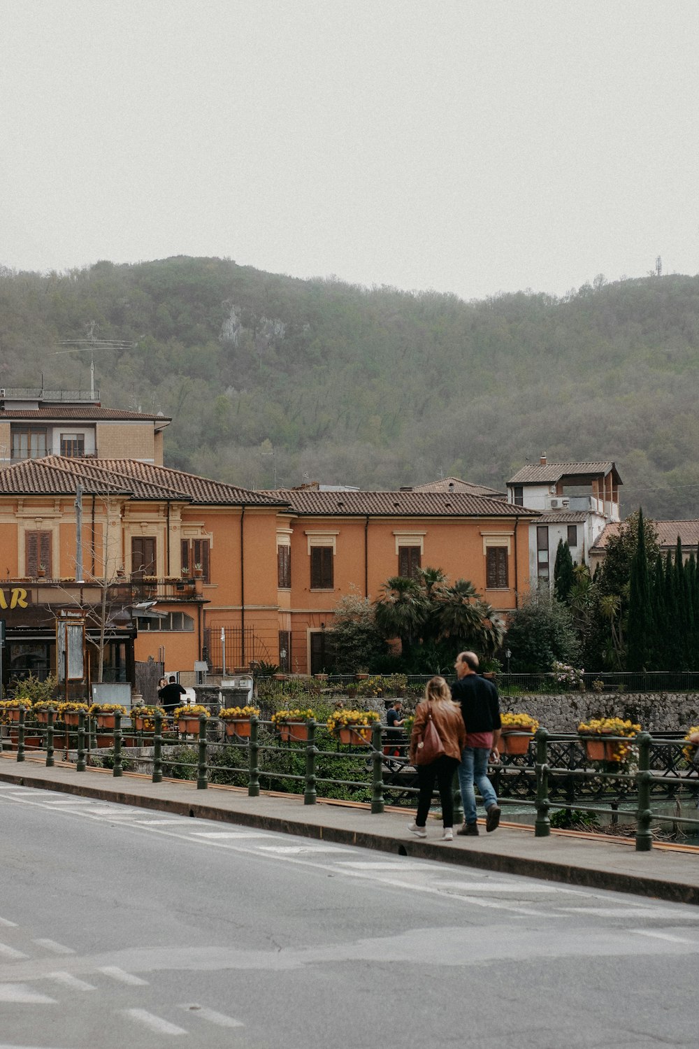 a couple of people walking across a street