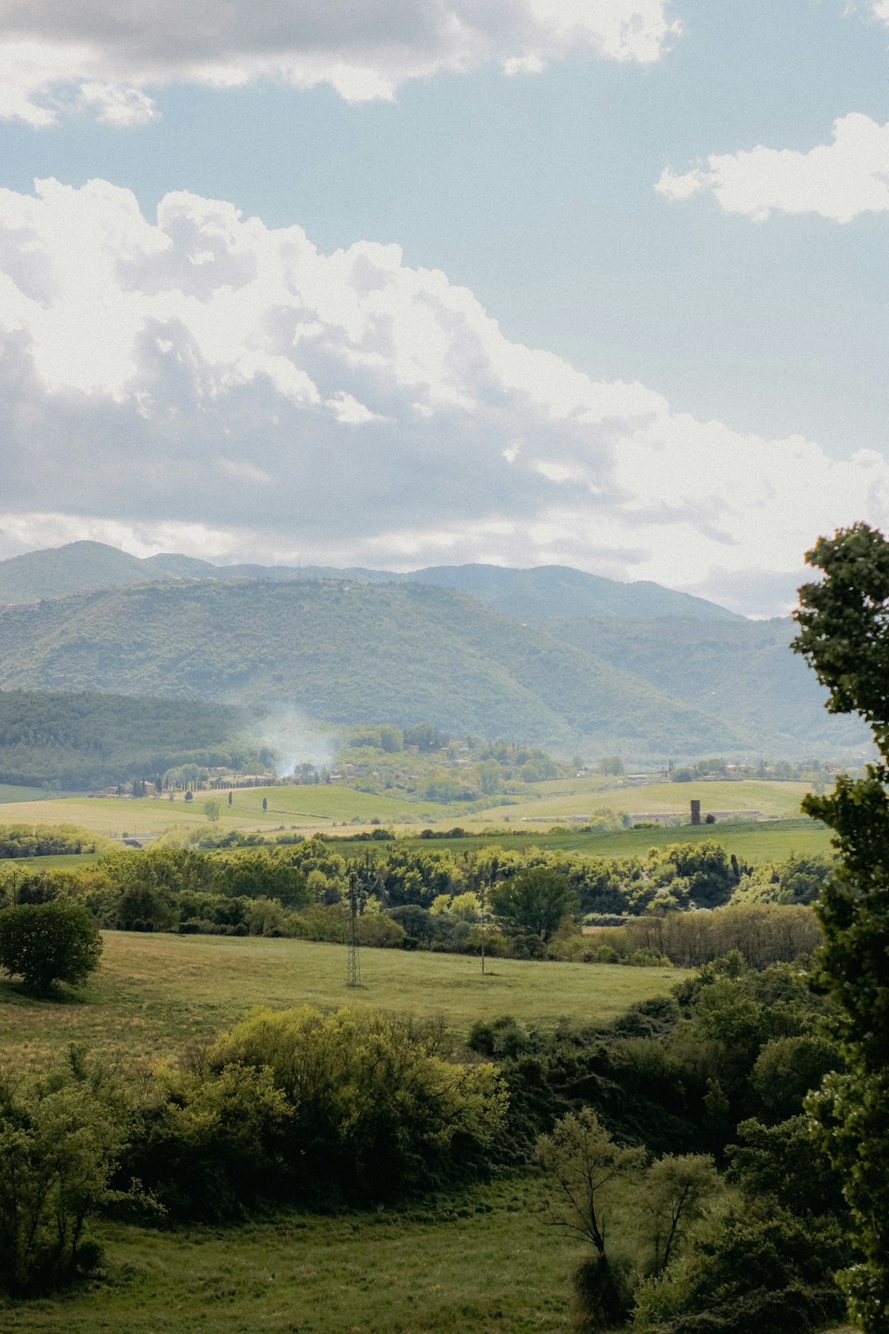 a view of a field with mountains in the background