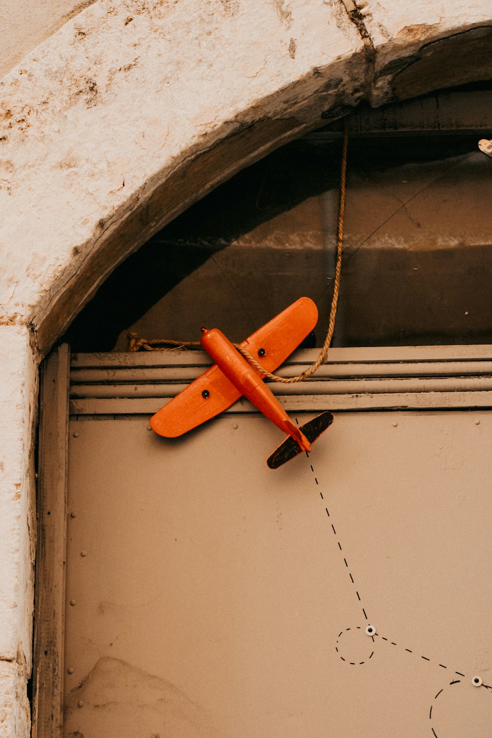 a toy airplane is hanging on a door
