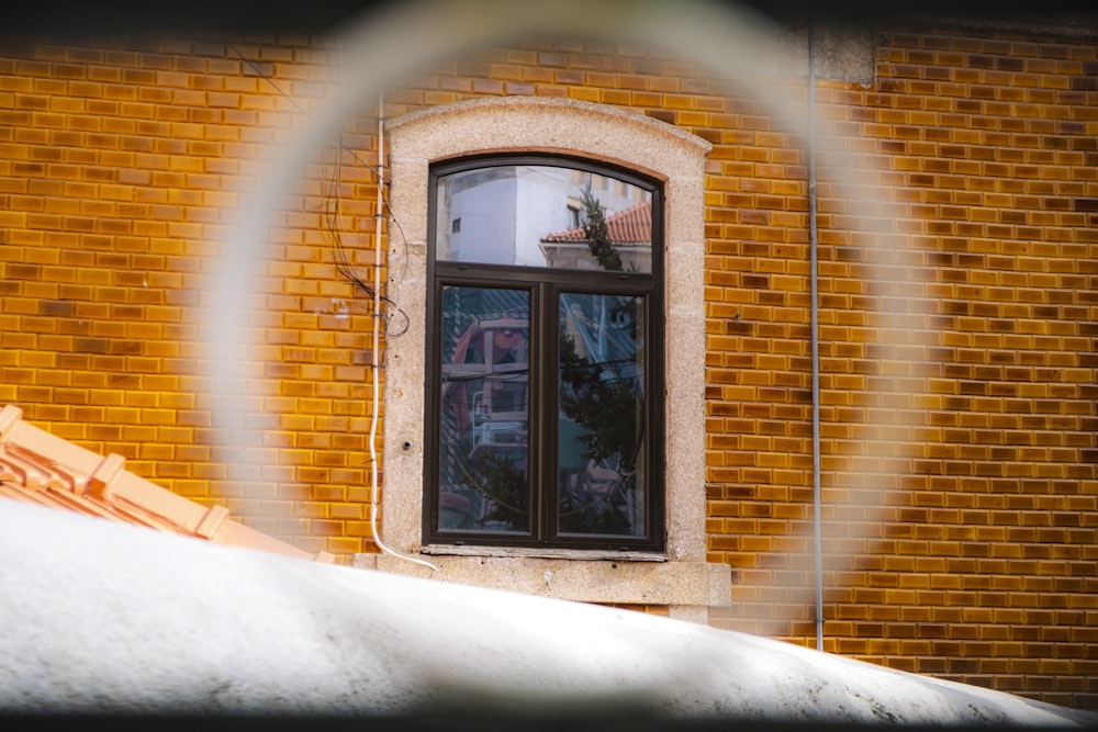 a brick building with a round window in front of it