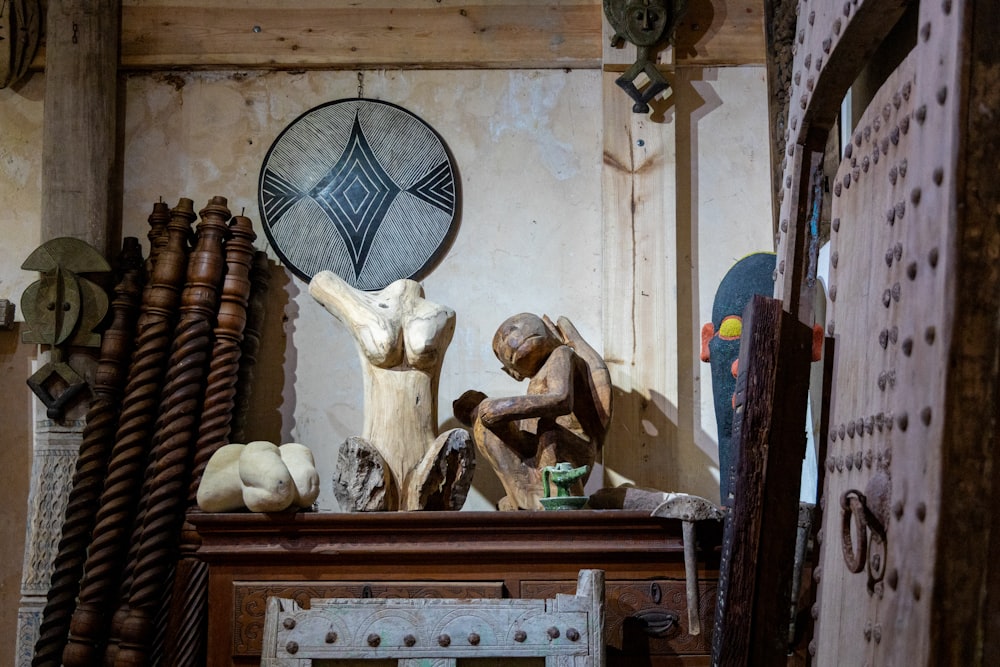 a wooden table topped with sculptures of animals