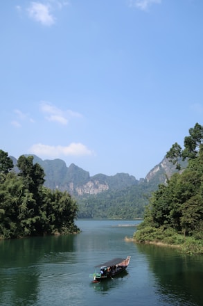 a long boat floating on top of a river