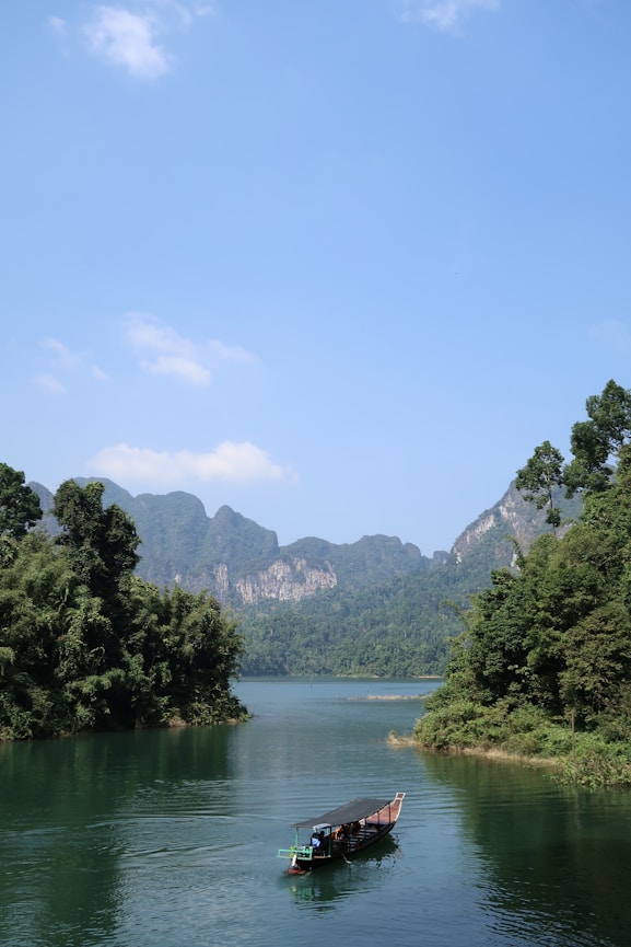 a long boat floating on top of a river