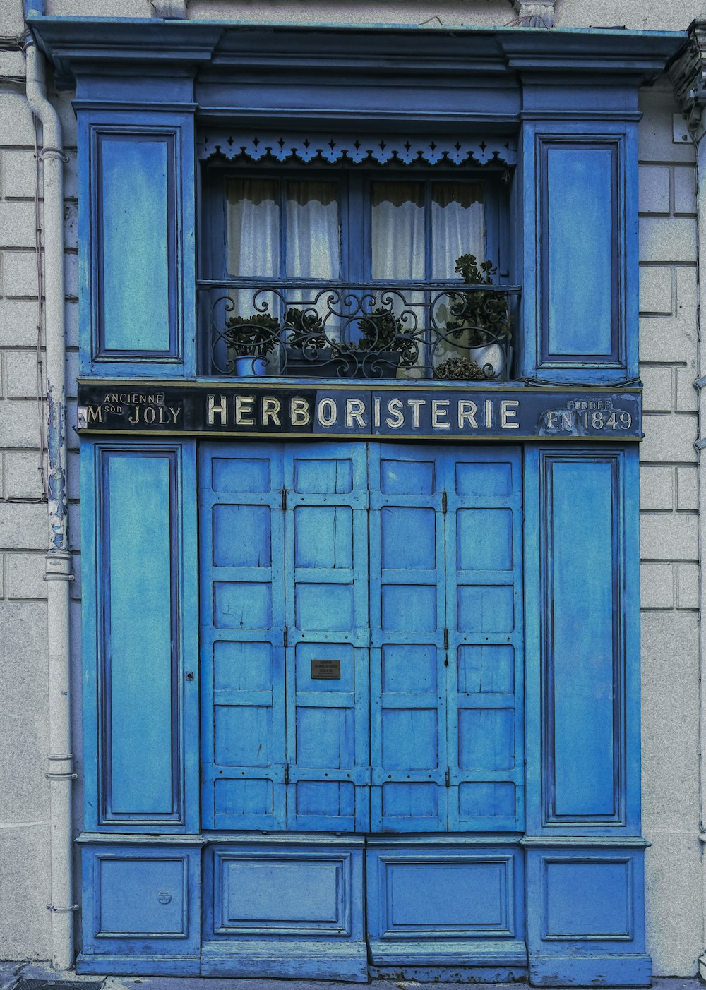 a blue door with a sign on it