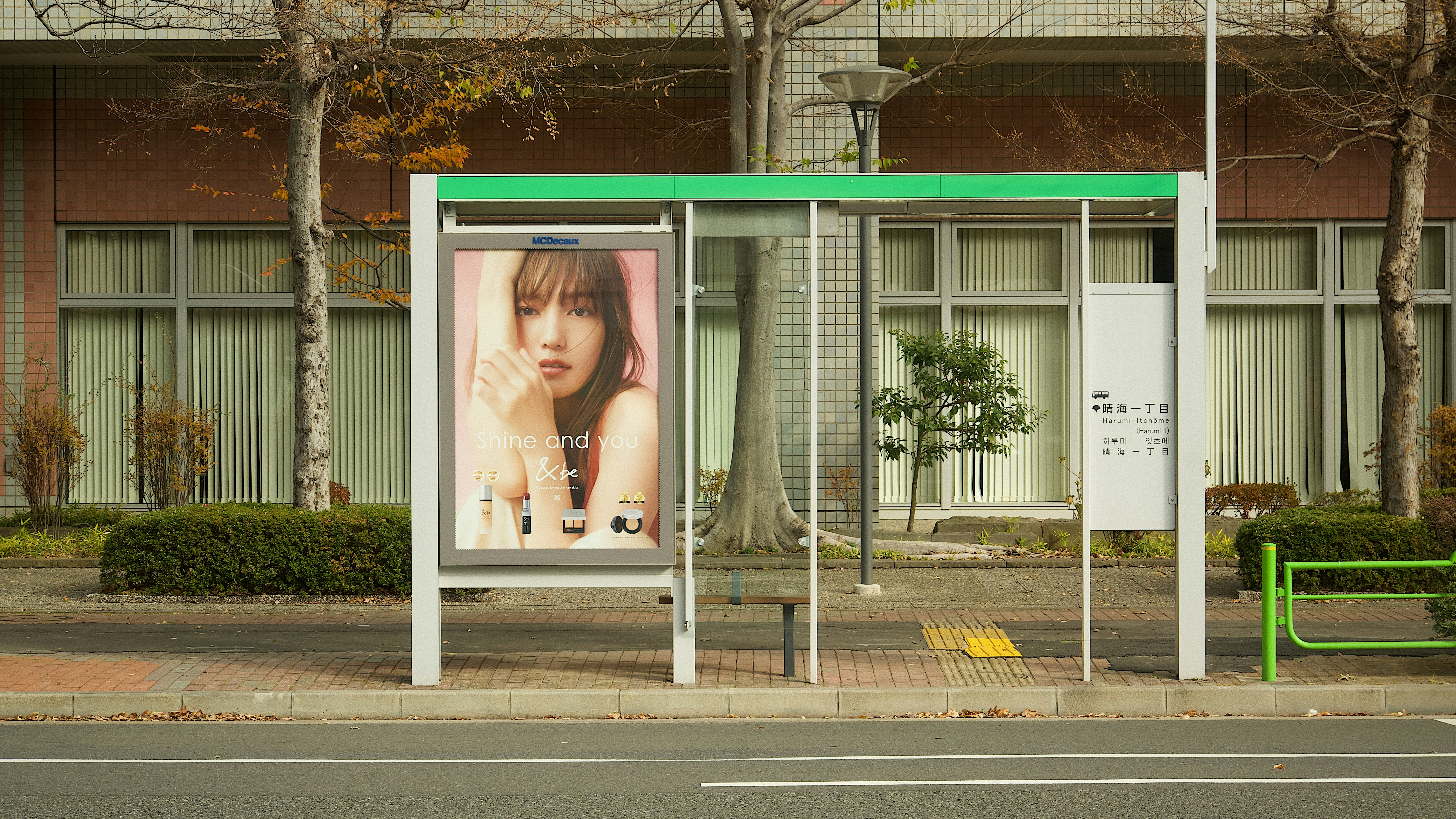a bus stop with a billboard on the side of it