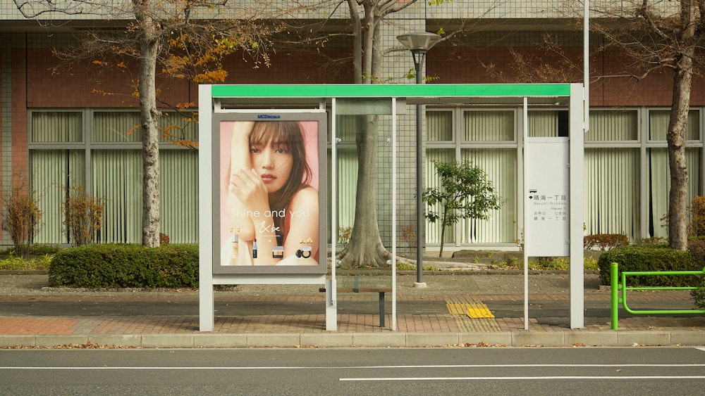 a bus stop with a billboard on the side of it