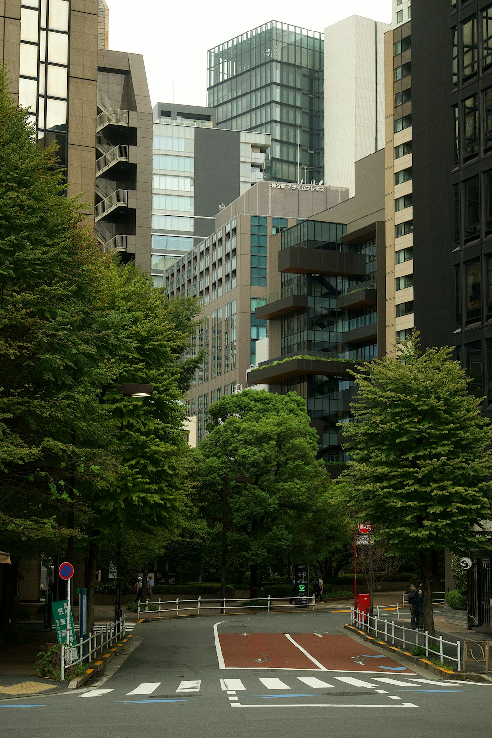 a city street with tall buildings in the background