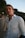 a man in a white shirt is posing for a picture