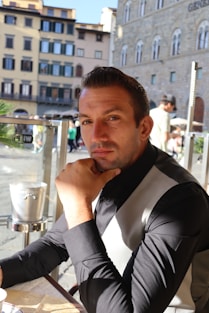 a man sitting at a table with a plate of food
