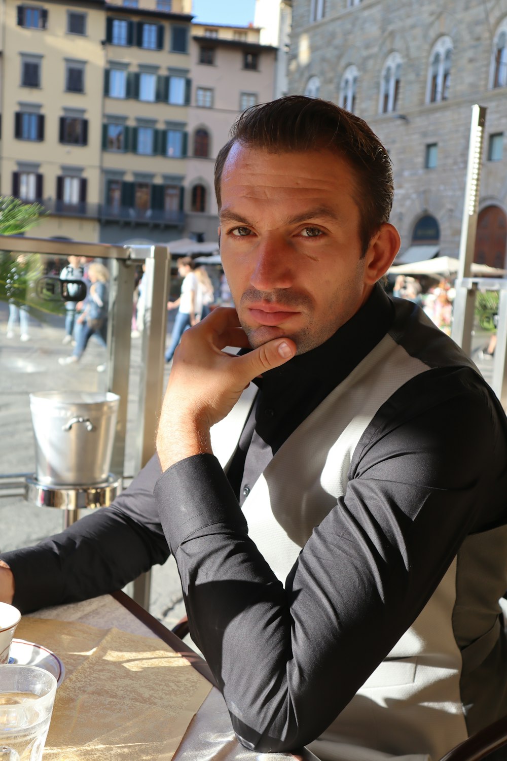 a man sitting at a table in front of a window