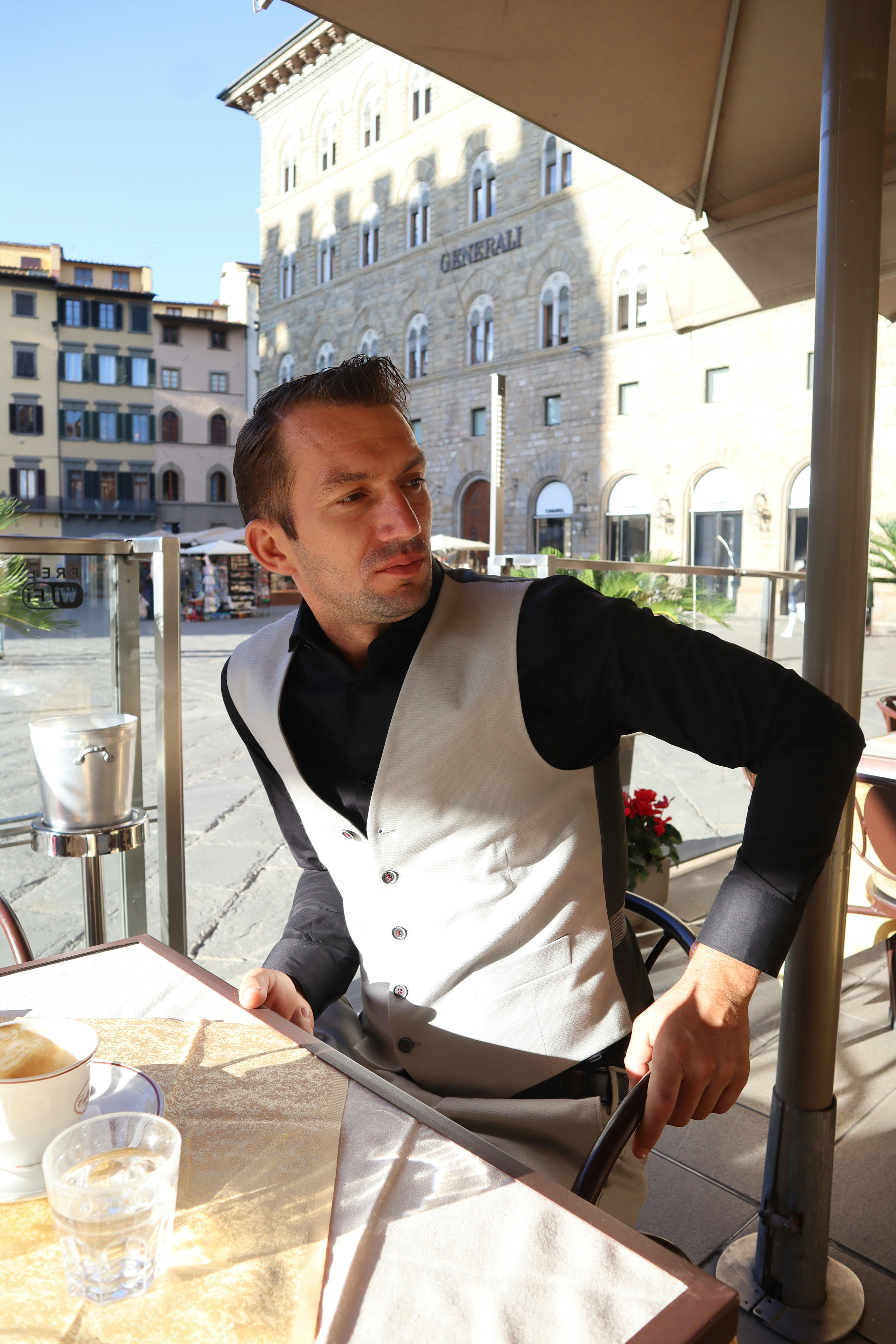 a man sitting at a table with a knife in his hand
