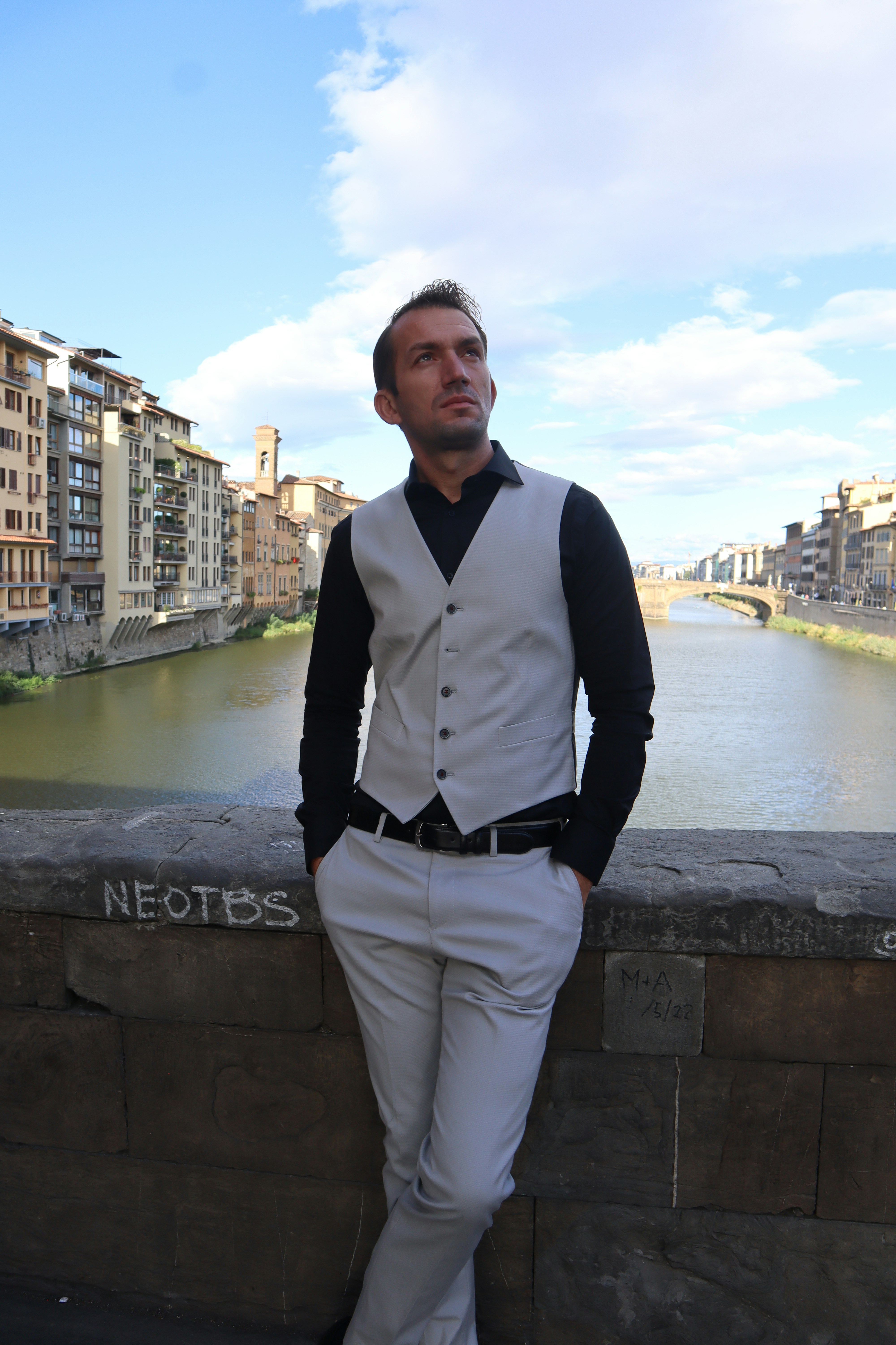 A man in a white suit leaning against a wall photo – Free Portrait ...