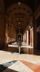 a person walking down a hallway in a building
