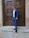a man in a blue suit standing in front of a door