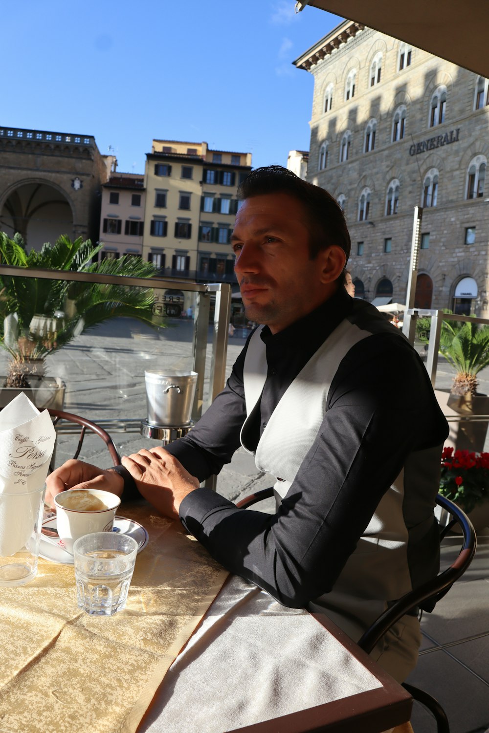 a man sitting at a table looking at his cell phone