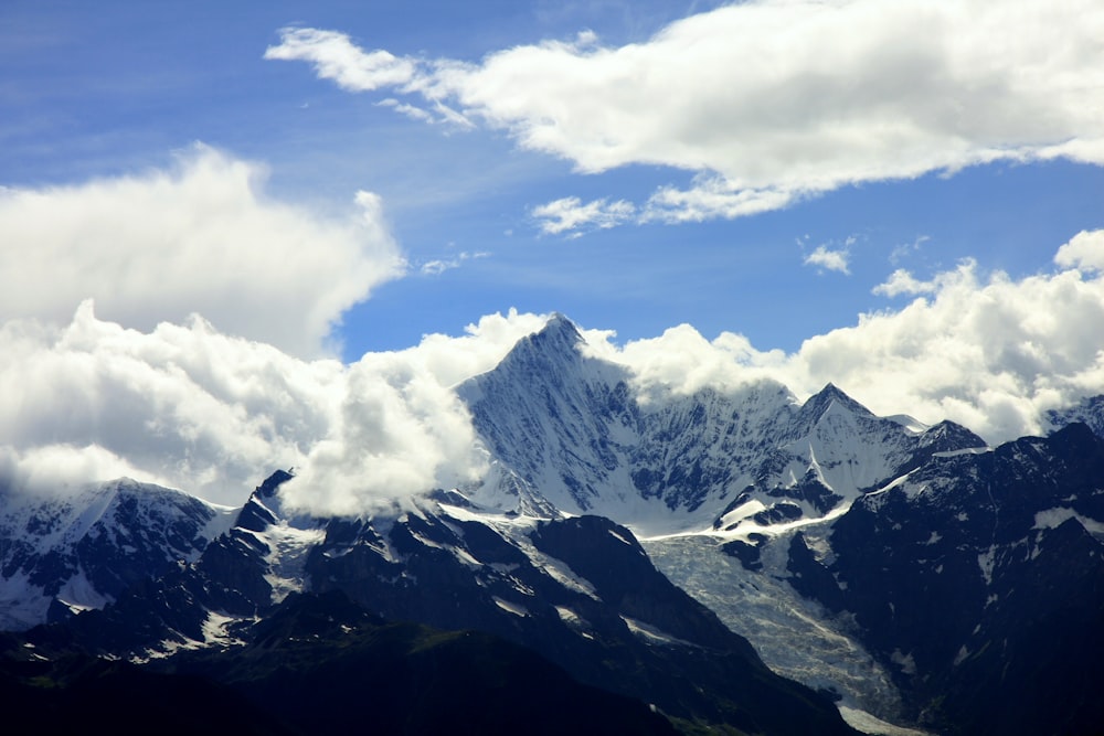 a view of a mountain range with clouds in the sky