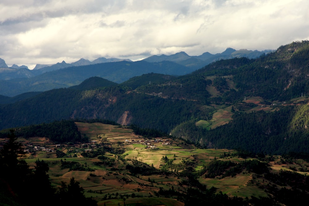 a view of a valley with mountains in the background