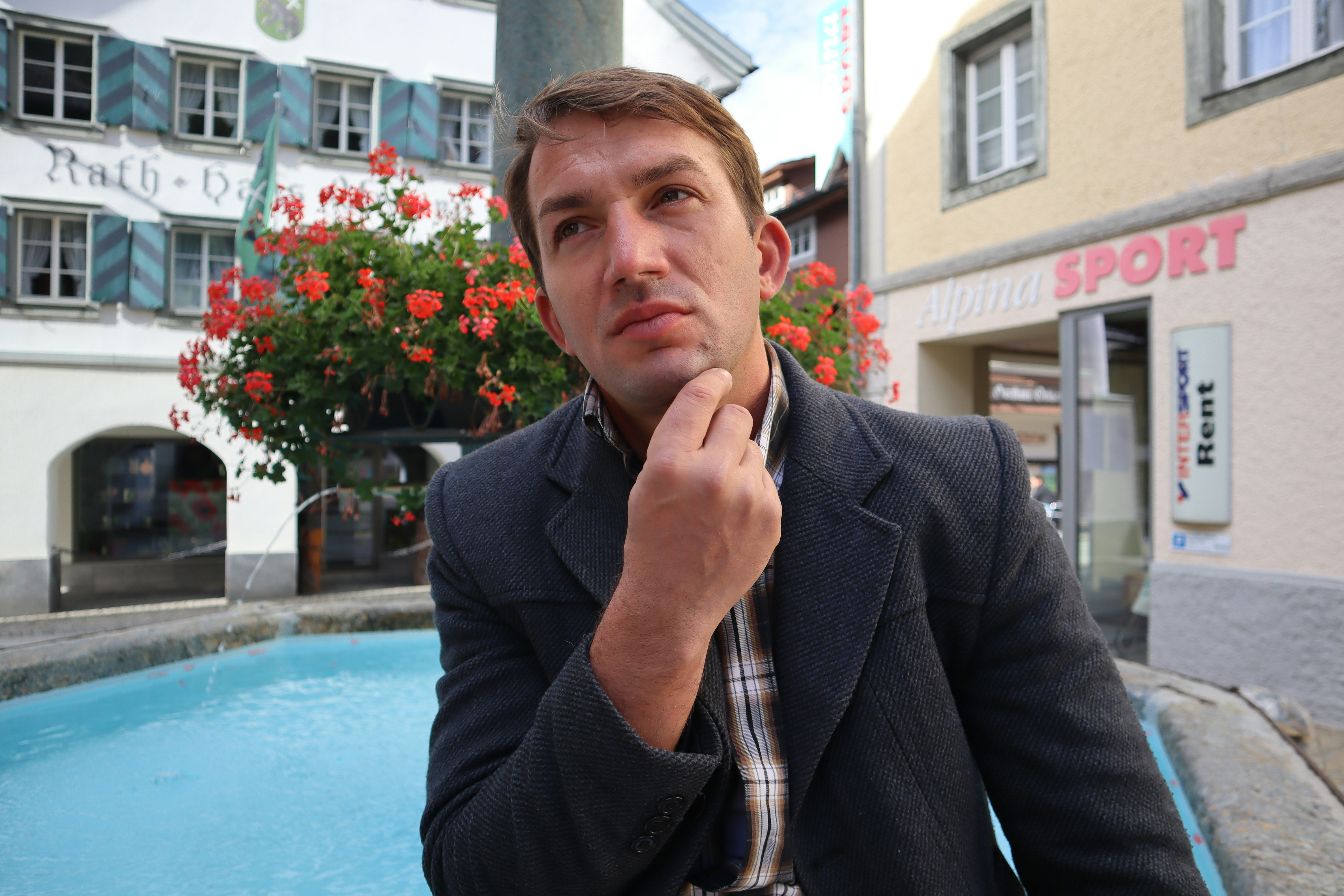 a man sitting in front of a pool of water