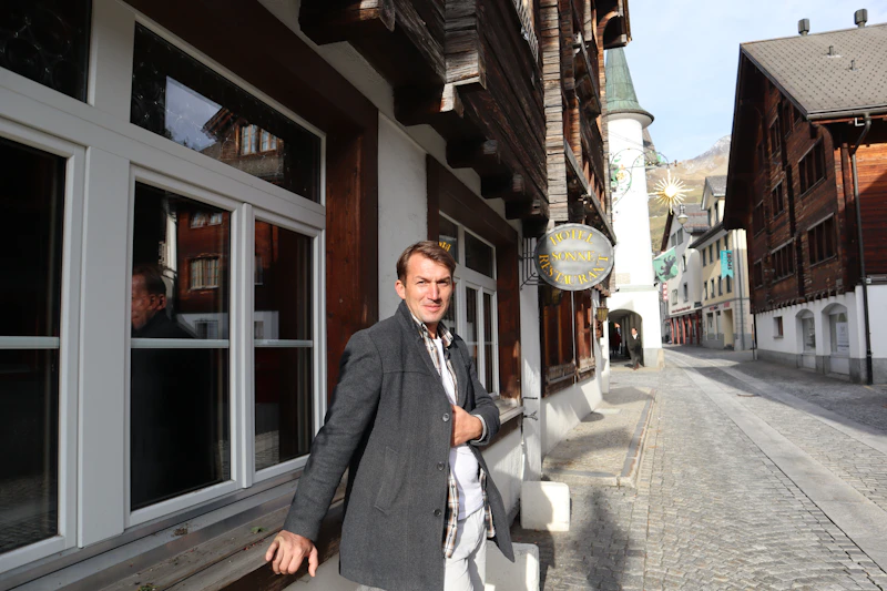 a man is standing outside of a building