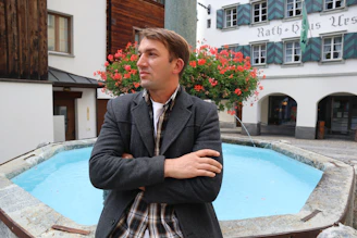 a man standing in front of a pool of water