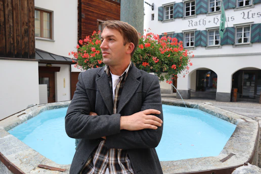 a man standing in front of a pool of water