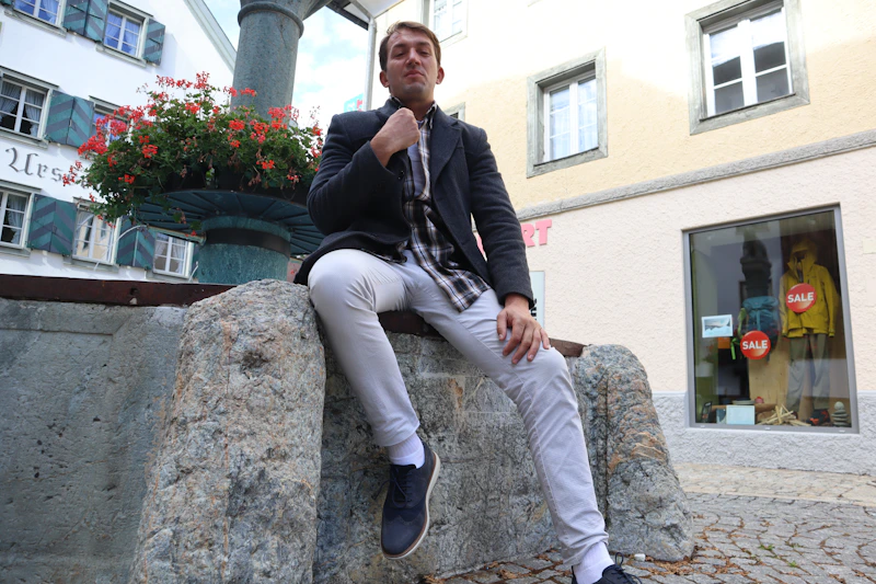 Man on stone wall, relaxed urban lifestyle