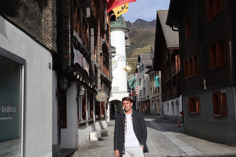 gay man walking between buildings