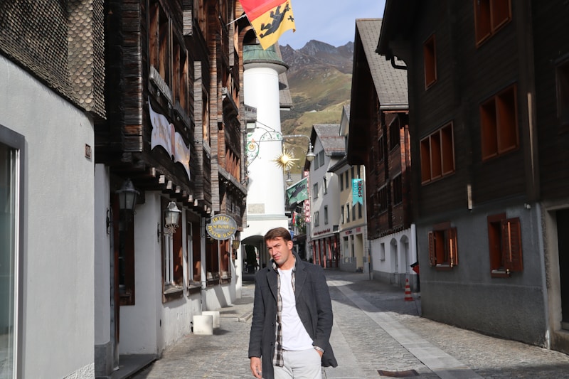 gay man walking between buildings