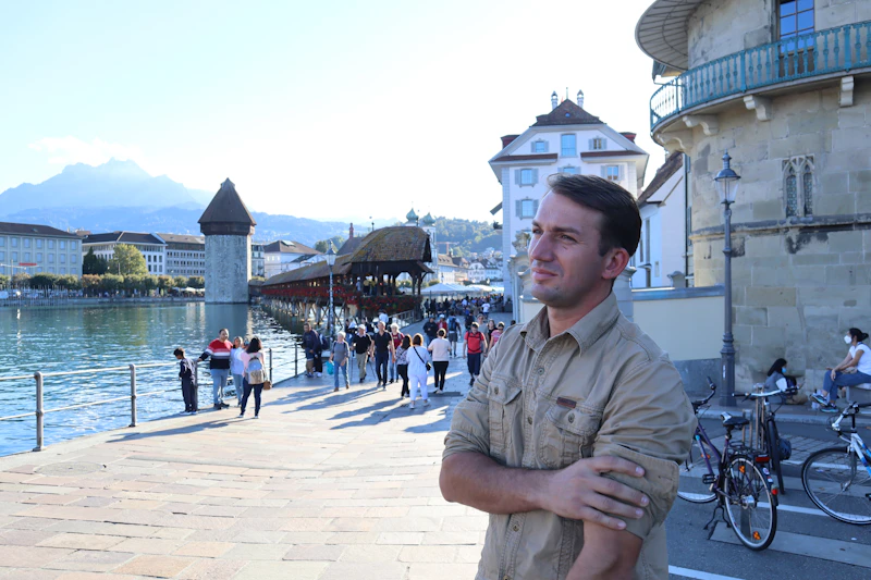 a man standing in front of a body of water