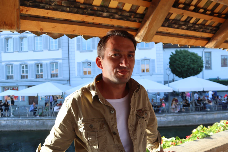 relaxed man under a wooden roof by the river