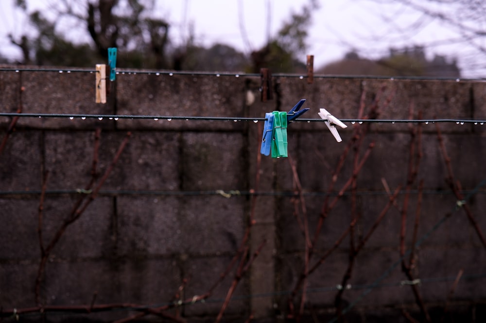 a pair of scissors are hanging on a wire