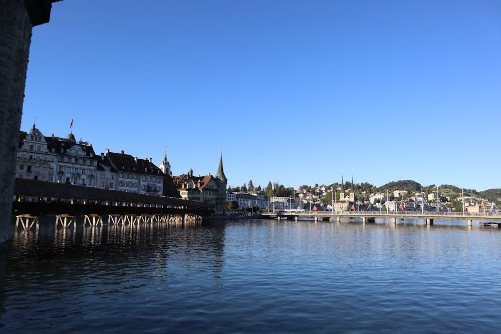 a bridge over a body of water with buildings in the background