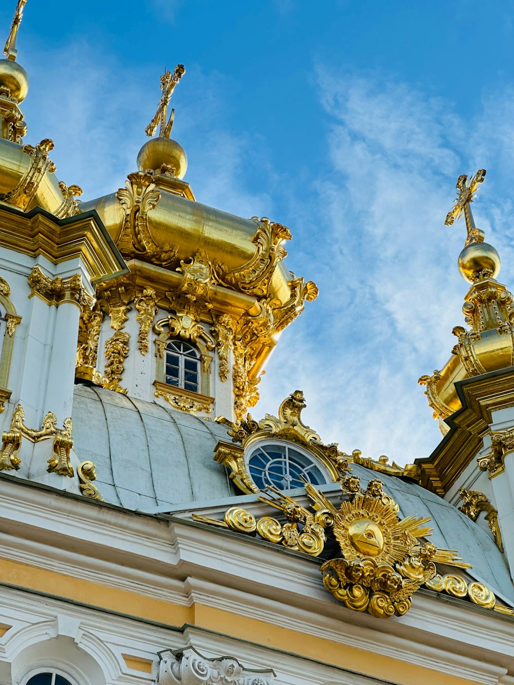 Ein gold-weißes Gebäude mit einer Uhr auf dem Dach