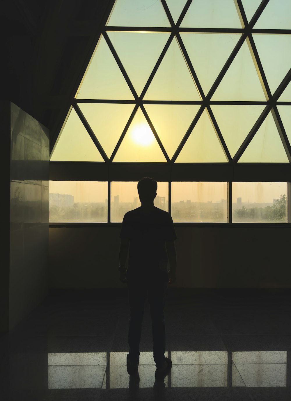 a man standing in front of a large window