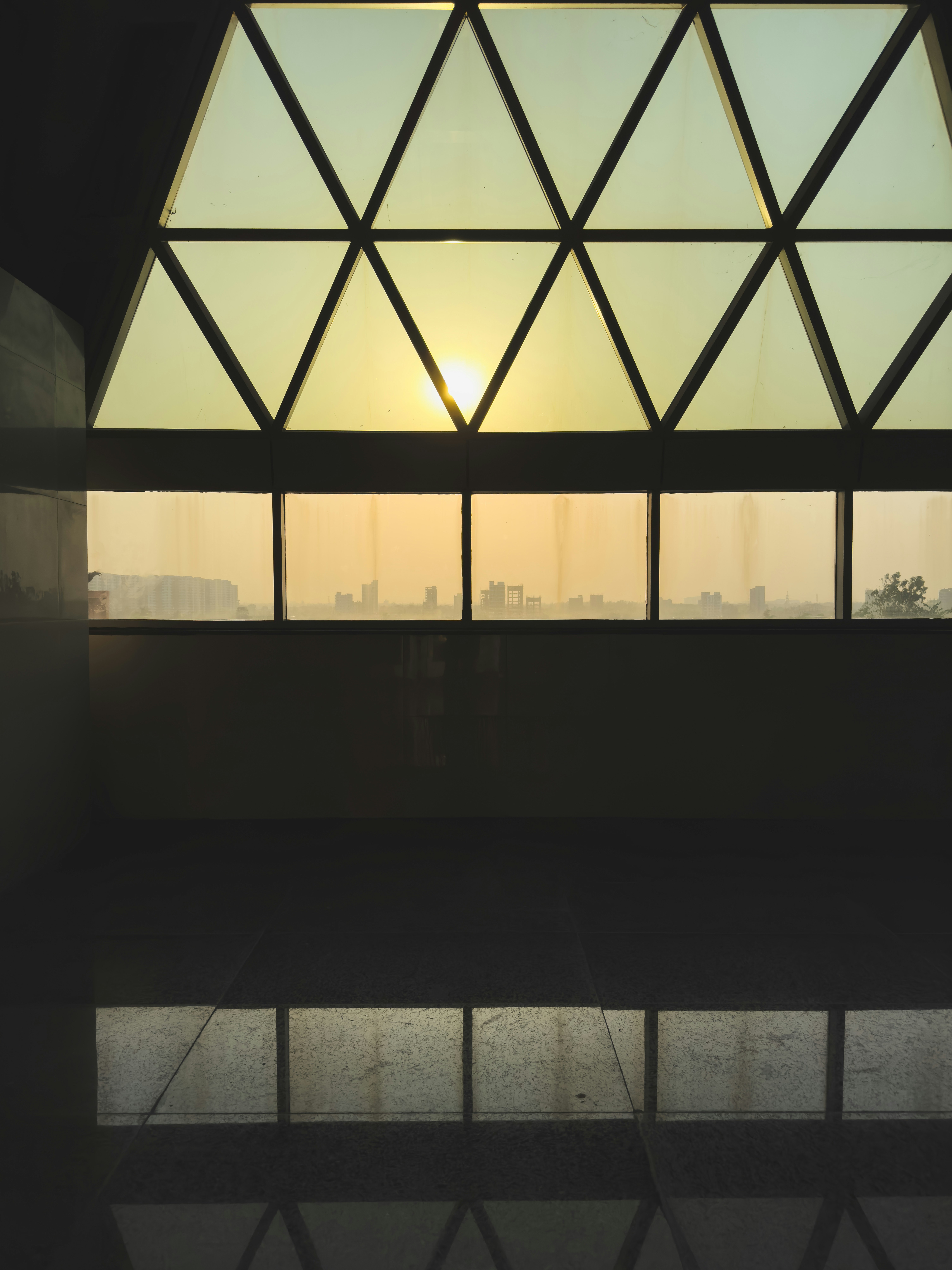 the sun is shining through a window in a building