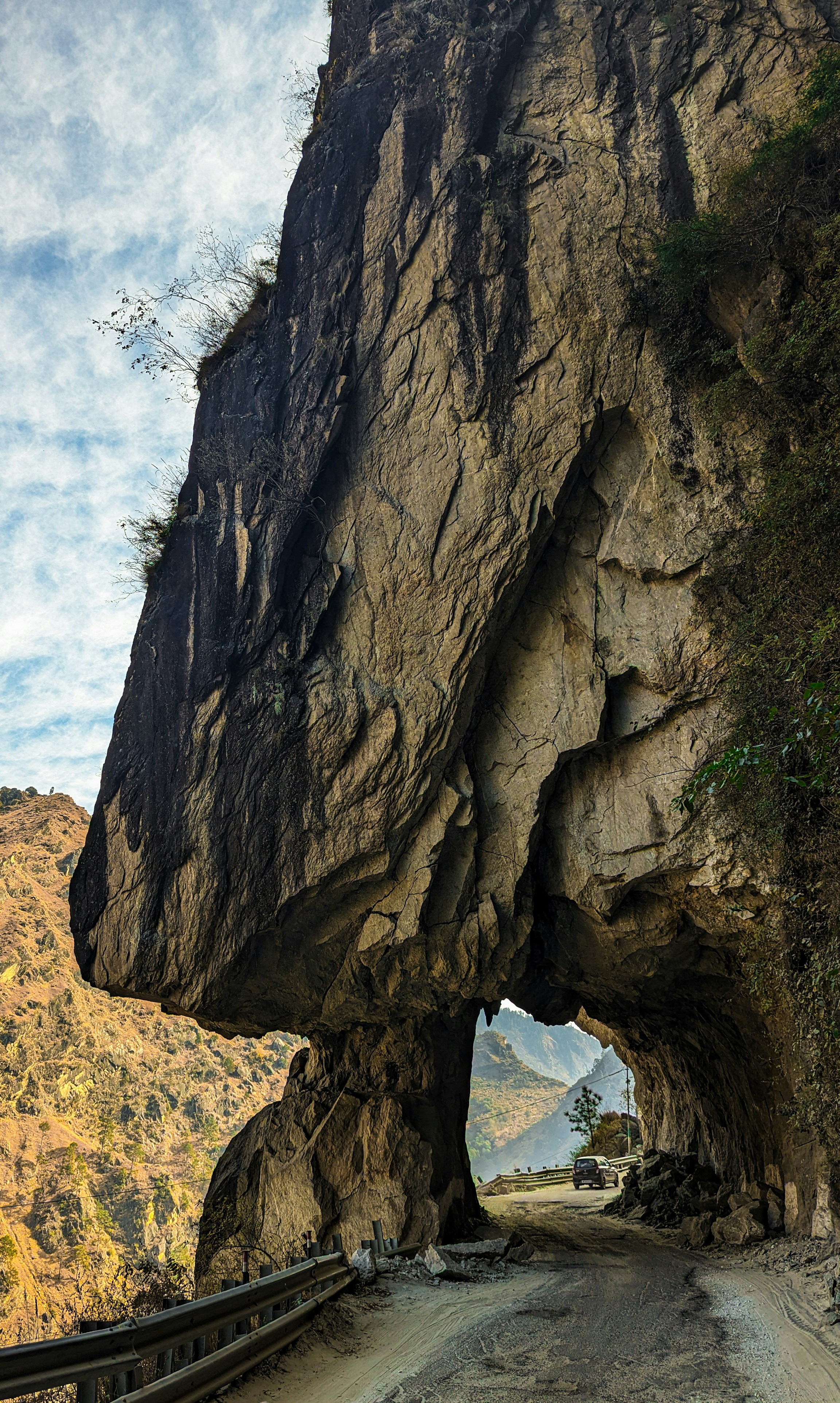 a large rock formation on the side of a road