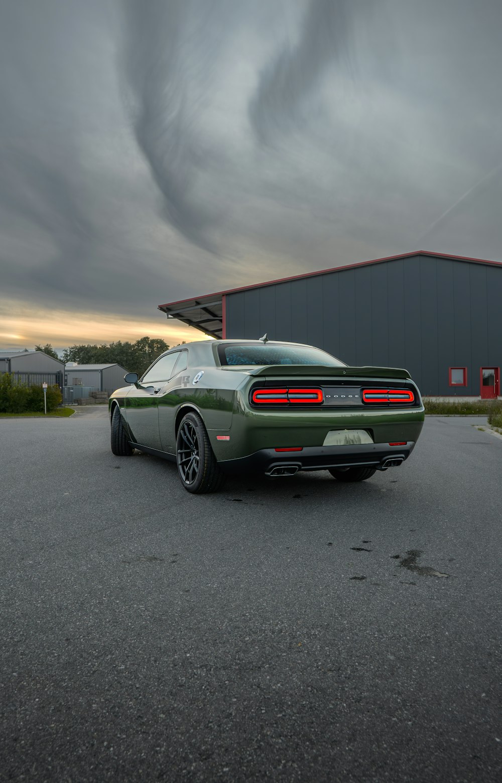 a green sports car parked in a parking lot