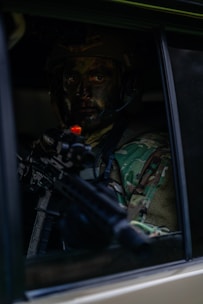 a man with a gun in a car